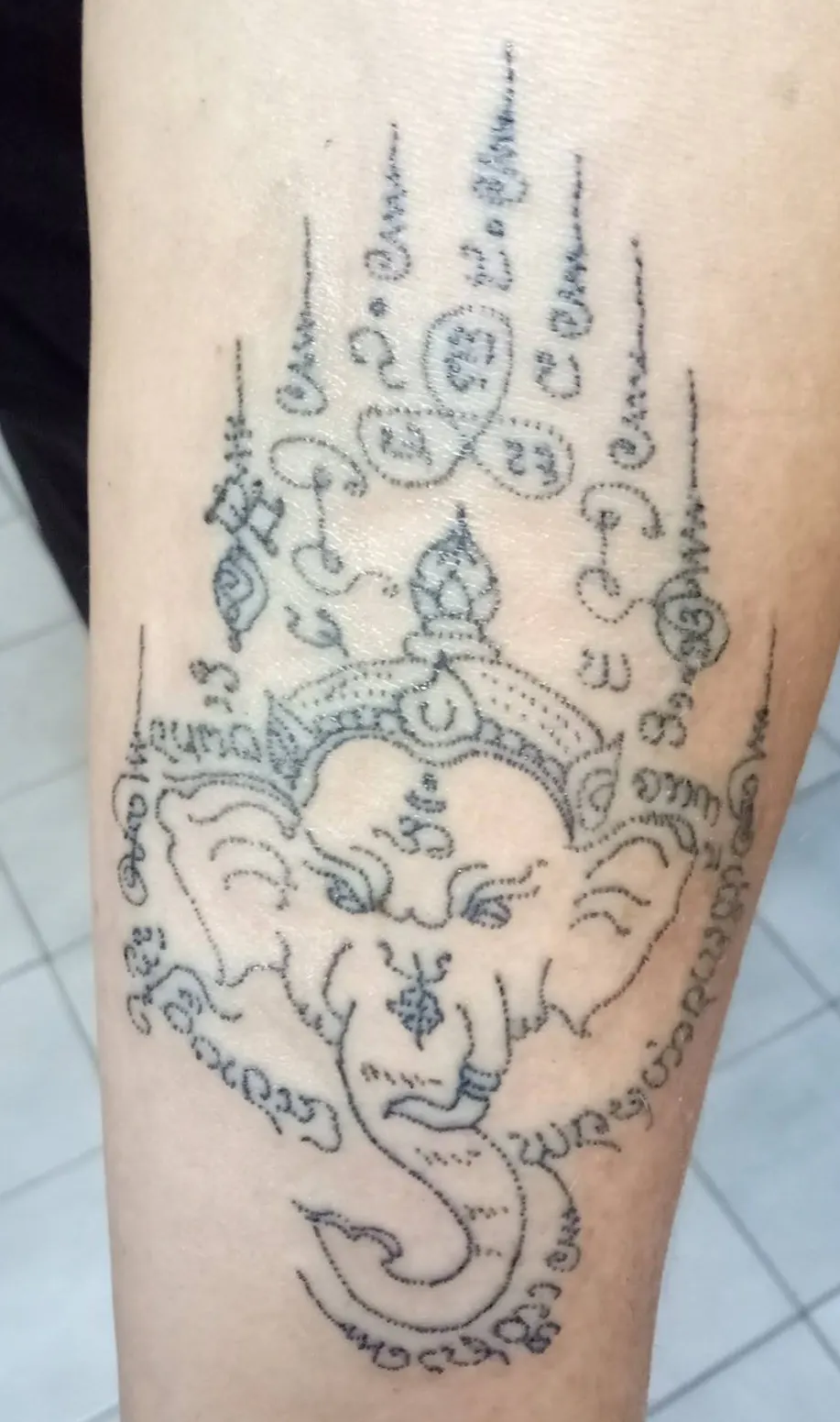 Ganesha Sak Yant design tattooed on the forearm