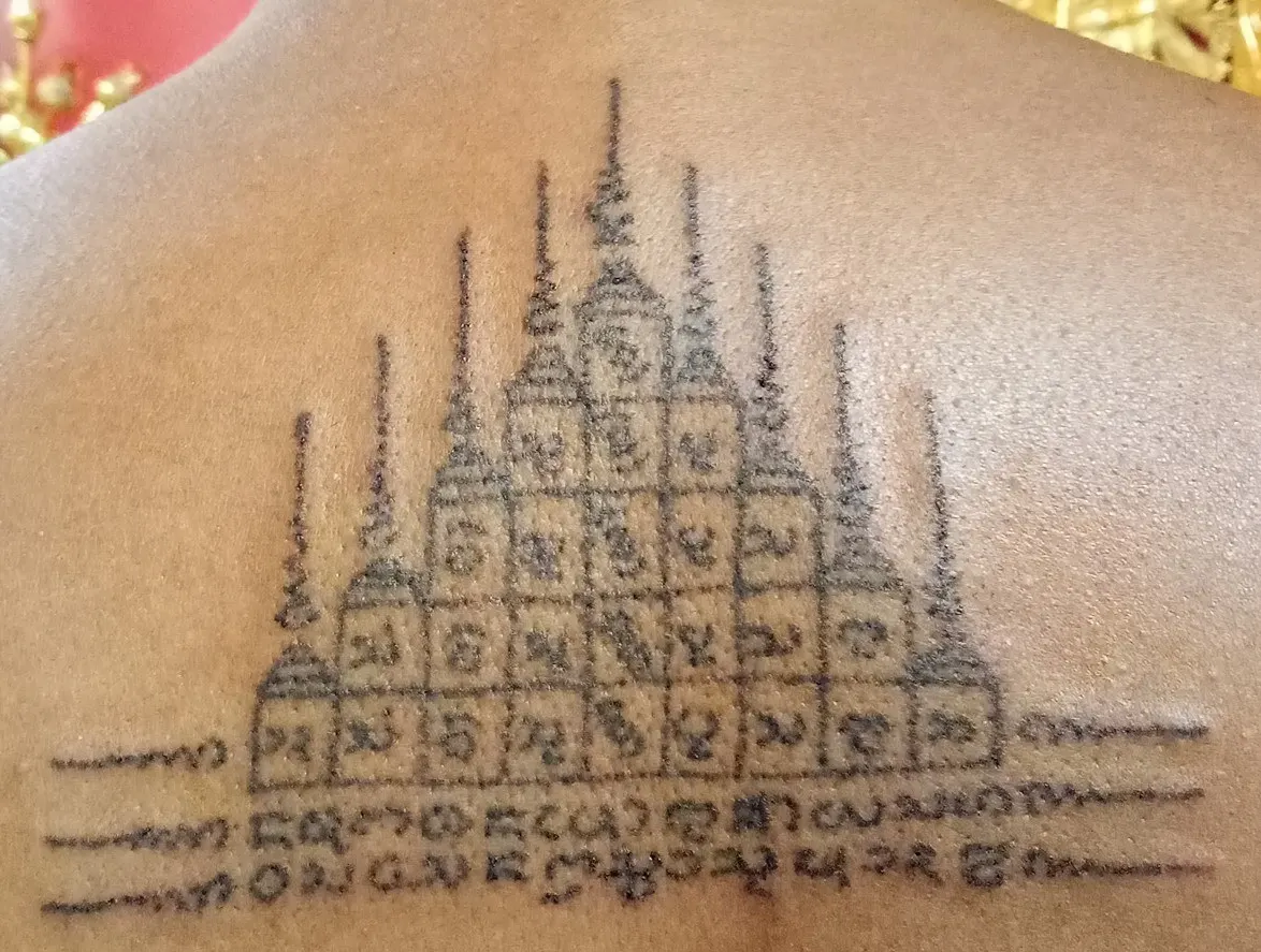 Pagoda spires Sak Yant design tattooed on the shoulder