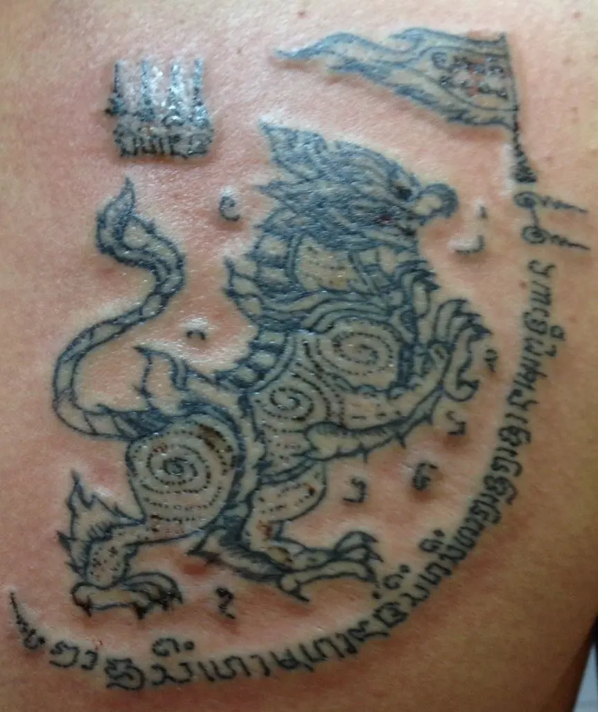 Singha lion Sak Yant design with sacred flag and script